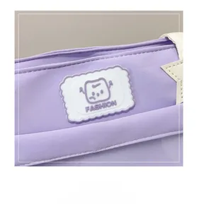 Detail of lavender canvas tote showing a cute cartoon badge and starfish star patch