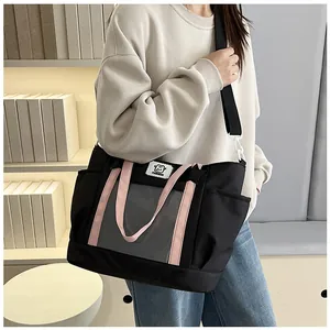 Detail of large capacity ita bag with clear window and pink straps for anime pins