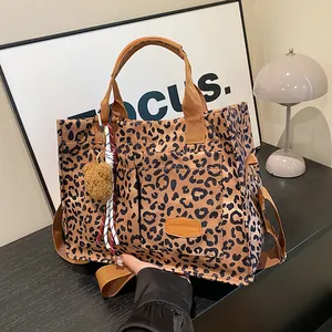 Large leopard print canvas tote bag with crossbody strap and fashion bear pendant