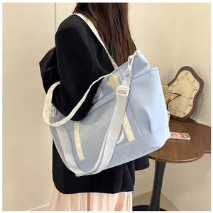 Detail of light blue ita bag with transparent window, star patch and woven strap