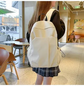Détail d'un sac à dos d'ordinateur minimaliste blanc cassé avec poches latérales à cordon