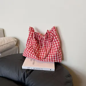 Red and white gingham tote bag with bow tie straps in a minimalist vintage style
