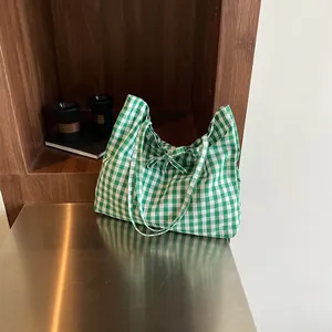 Minimalist green and white checkered canvas tote bag with decorative bow tie details