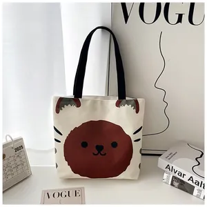 Detail of cute cartoon animal print on large cream canvas tote bag with black handles