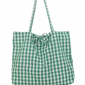 Green and white gingham tote bag with a decorative bow and long shoulder straps