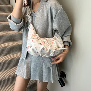 Chic floral dumpling shoulder bag with ruched straps and bow details for women