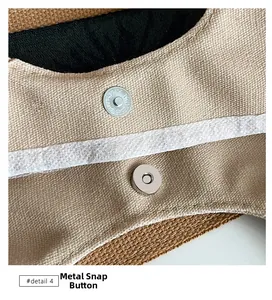 Detail of the high-quality magnetic closure on a beige canvas tote bag with woven texture