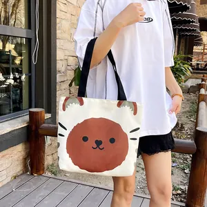 Japanese style canvas tote bag with a cute brown cartoon animal print and black handles