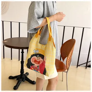 Detailed view of yellow plaid canvas tote bag with funny girl cartoon illustration
