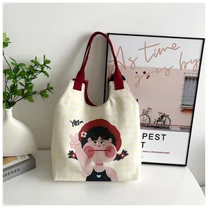Detail of canvas tote bag featuring yellow gingham pattern and cartoon girl illustration