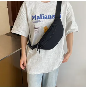 Close-up of a large capacity waterproof black waist bag worn crossbody style for men