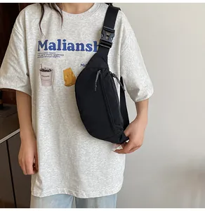 Detailed close-up of a durable black waterproof fanny pack with adjustable wide shoulder strap