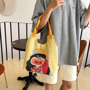 Vibrant yellow plaid canvas tote bag featuring cute cartoon girl illustration for women