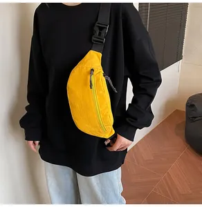 Close-up of bright yellow waterproof nylon waist bag with adjustable black strap