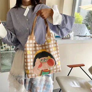 Cartoon girl illustration plaid canvas tote bag shown in a cozy cafe setting