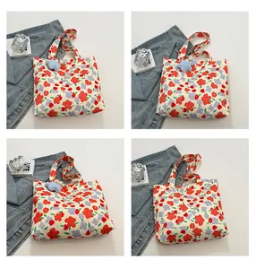 Floral canvas tote bag details with blue star plush charm and large flower patterns