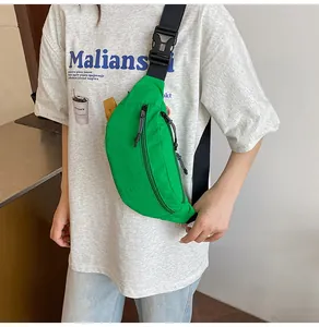 Detail view of bright green waterproof waist bag with black adjustable strap and sturdy buckles