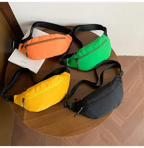 Close-up of four nylon crossbody bags in vibrant colors with adjustable woven straps