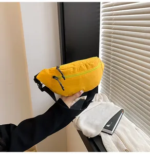 Detail of durable bright yellow waterproof waist bag with double zippers and black straps