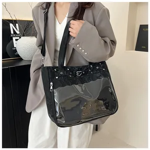 Detail of black ita bag with large clear PVC window and heart-shaped metal buckle