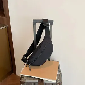 Waterproof large capacity black waist bag for work and sports on a grey suitcase handle