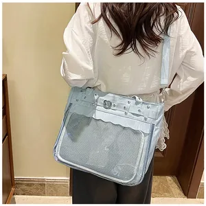 Détail du sac ITA bleu clair avec fenêtre transparente, rivets en cœur et bord ondulé