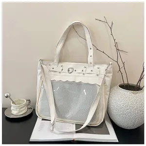 Detail of cream canvas bag with heart metal buckle and ruffled pocket design