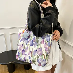 Floral canvas tote bag with purple tulips and star charm on female shoulder