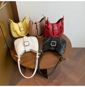 Close-up of stylish mini shoulder bags in five colors with silver buckle and rivet details