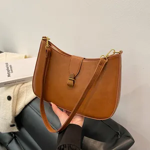 Vintage brown PU leather half-moon baguette bag with elegant bronze metal buckle detail