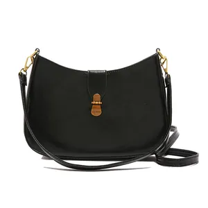 Retro black leather underarm crescent bag with vintage gold metal clasp and thin strap