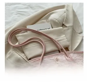 Detailed lace texture with 3D butterfly embroidery and knotted handle on a pink tote bag
