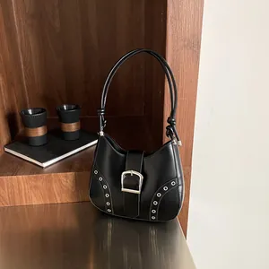 Retro black leather half-moon shoulder bag with silver buckle and stud details