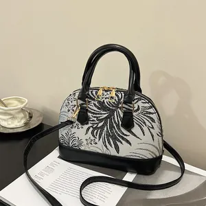 Retro shell shoulder bag with black and white floral jacquard print and leather handles