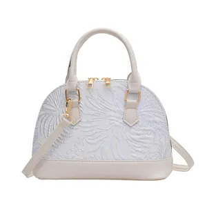 Retro off-white shell bag with floral embroidery and gold dual zipper closure