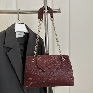 Chic burgundy snakeskin pattern shoulder bag with gold chain strap for professional women