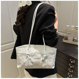 Detailed view of white floral lace handbag with 3D butterfly appliqués and thin straps