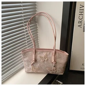Detailed close-up of pink lace shoulder bag with three 3D butterfly embroidery appliques