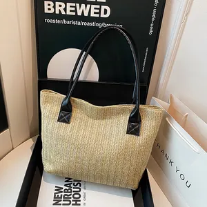 Vintage woven beige tote bag with black leather straps for beach and summer travel