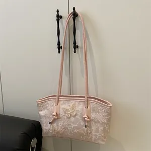 Pink lace tote bag with 3D butterfly floral accents and slender leather straps