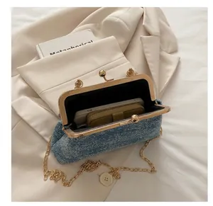 Detail showing the internal capacity and blue denim fabric of this chain shoulder bag