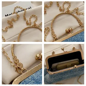 Detail of blue denim chain bag with golden floral relief handles and sequins