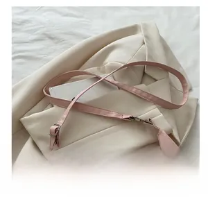 Detail of adjustable pink leather strap on a Chinese style floral print shoulder bag