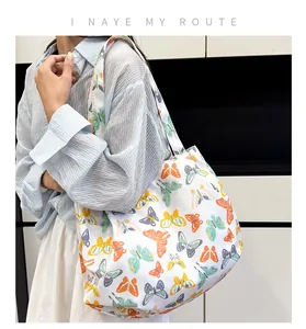Detail of a large white canvas tote bag featuring colorful butterfly patterns for women