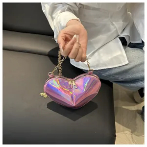 Detail of heart-shaped iridescent purple laser bag with golden chain and double zipper