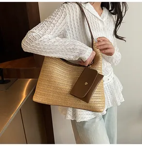 Detail of a woven hobo bag with a brown leather pouch on a casual summer outfit
