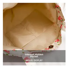 Detail of floral canvas tote bag showing internal hidden pocket and magnetic buckle