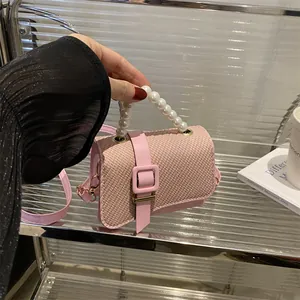 Pink woven square crossbody bag with pearl handle and golden buckle for women