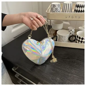 Detailed macro of a heart-shaped holographic bag with rainbow shine and gold chain