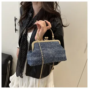 Blue retro crossbody bag with white dots, golden metal frame, and chain strap detail